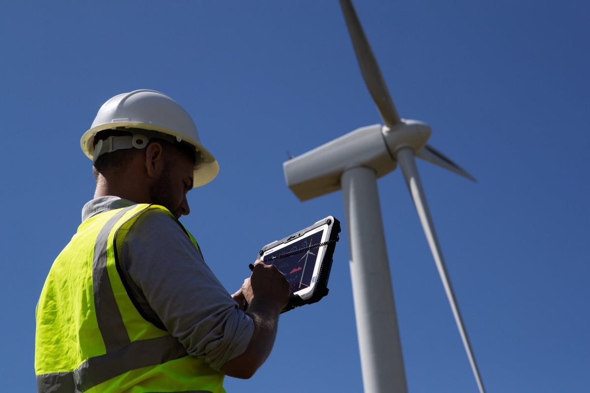 Wind farm engineer using the Panasonic TOUGHBOOK G2 mk3 (Wi-Fi, micro-SD reader, fingerprint reader, Swiss plug) rugged tablet outdoors in direct sunlight